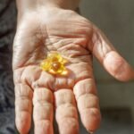 Close-up of elderly hand with supplement