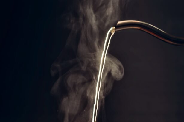 The process of brewing tea, pouring hot water from the kettle into the Cup, steam coming out of the mug, water droplets on the glass, black background